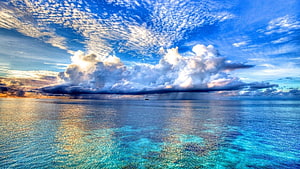 Stunning Ocean View With Dramatic Clouds And Turquoise Waters HD wallpaper
