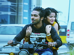 Sivappu Manjal Pachai Couple Riding Motorcycle in Urban Street Scene HD wallpaper