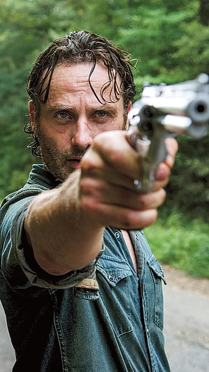 Rick Grimes Aiming Revolver in The Walking Dead Forest Scene HD phone wallpaper