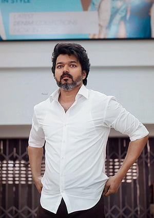 Vijay Sethupathi in a crisp white shirt posing confidently with hands on hips HD phone wallpaper