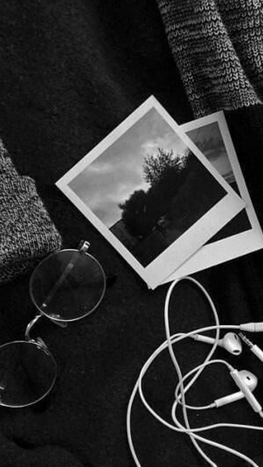 Monochrome Flat Lay With Polaroid Photos, Round Glasses, and Wired Earbuds on Dark Fabric HD phone wallpaper