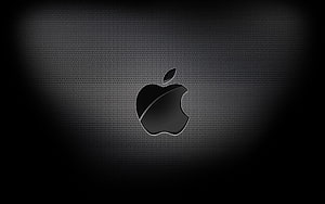 Sleek Black Apple Logo on Textured Mesh Background with Dramatic Lighting HD wallpaper