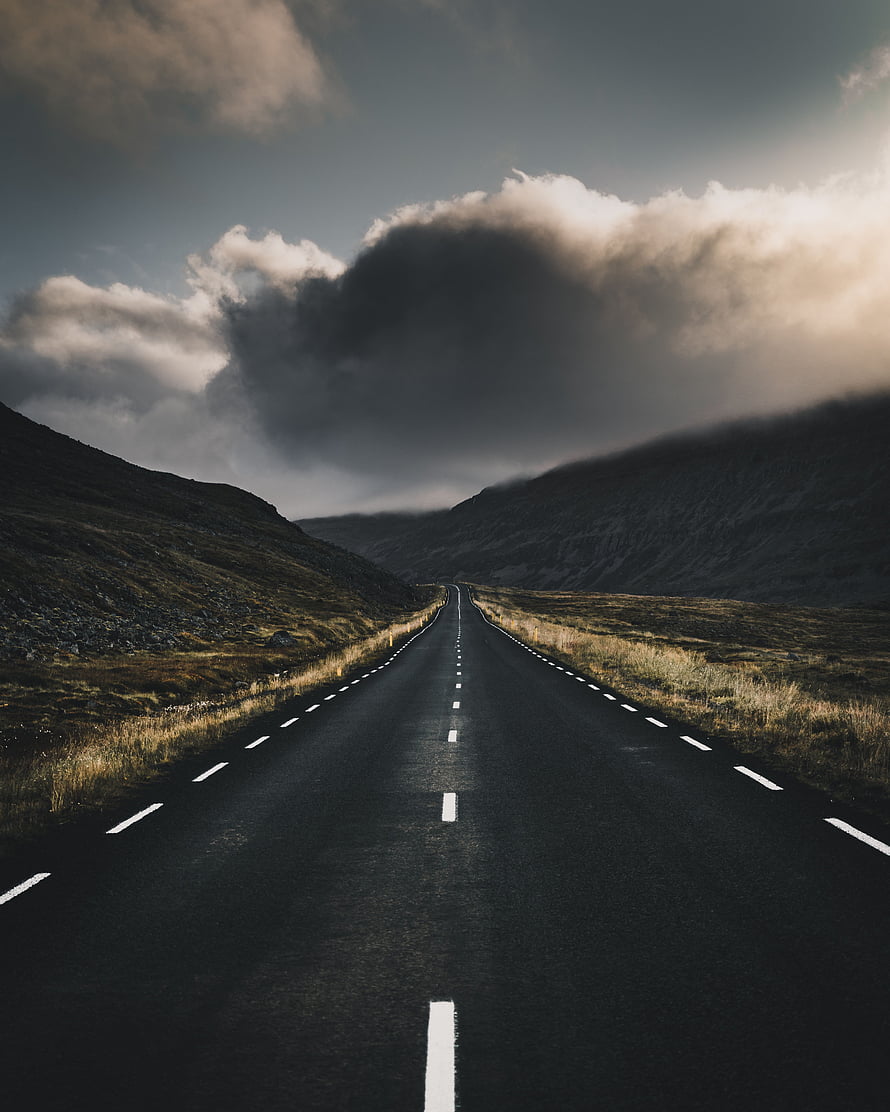 Moody Mountain Road Stretching Into Dramatic Storm Clouds HD phone wallpaper