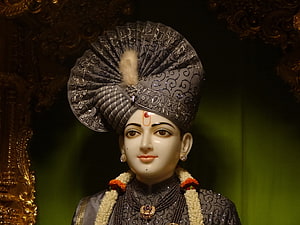 Ghanshyam Maharaj BAPS deity statue with ornate turban and floral garland HD wallpaper