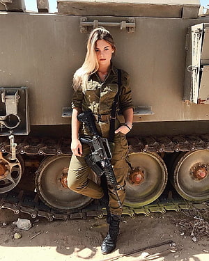 Female Soldier in Olive Fatigue Uniform Holding Rifle in Front of Armored Tank HD phone wallpaper