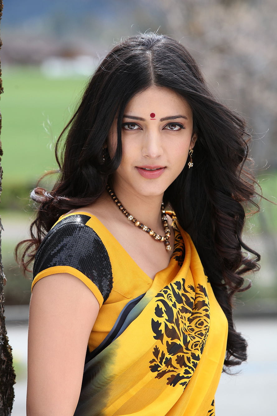 Shruti Hassan in a yellow and black floral sari with traditional jewelry HD phone wallpaper
