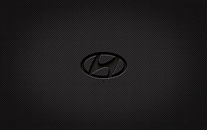 Hyundai emblem on dark carbon fiber texture with subtle diagonal weave pattern HD wallpaper