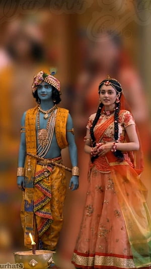 Radha Krishna in Traditional Indian Attire with Diya and Ornate Jewelry HD phone wallpaper