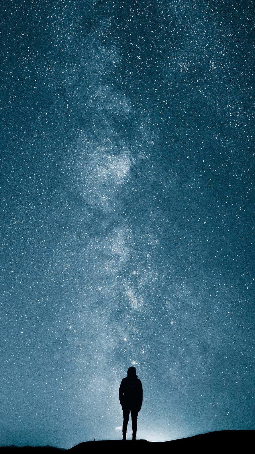 Silhouette of a Lone Figure Standing Beneath the Milky Way Galaxy at Night HD phone wallpaper