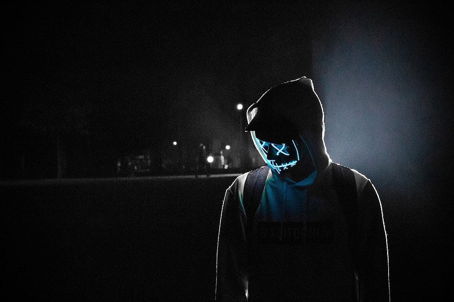 Mysterious Figure in Hoodie Wearing Glowing LED Mask in Dark Night Setting HD wallpaper
