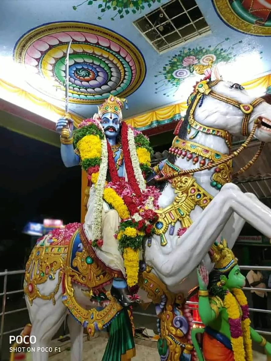 Vibrant Hindu deity statue on ornate white horse with floral garlands and sword HD phone wallpaper