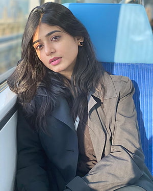 Sehar Khan in a tailored grey blazer with long dark hair and gold earrings HD phone wallpaper