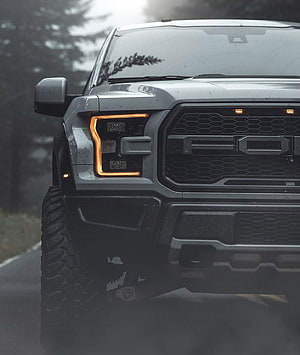 Front View of a Rugged Gray Ford F-150 Raptor Truck on a Wet Road HD phone wallpaper