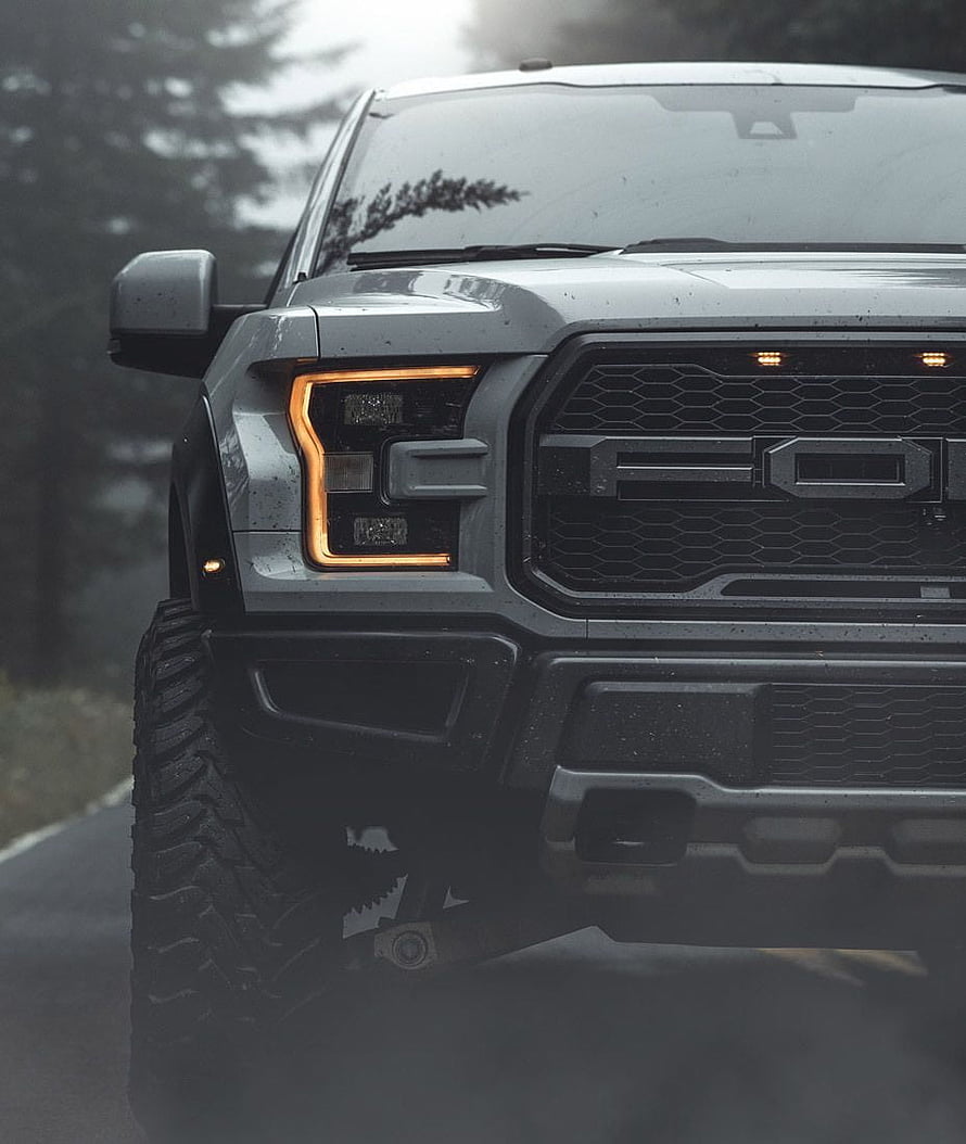 Front View of a Rugged Gray Ford F-150 Raptor Truck on a Wet Road HD phone wallpaper