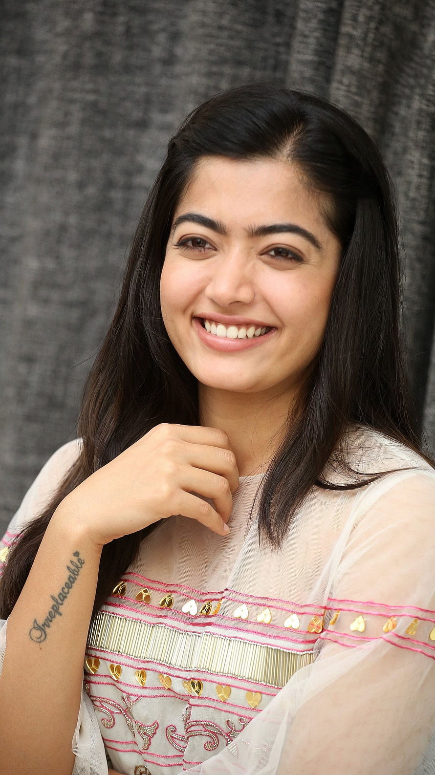 Rashmika Mandanna smiling portrait in embroidered white outfit with arm tattoo HD phone wallpaper