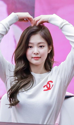 Jennie Kim from BLACKPINK Making a Heart Shape with Her Hands in a White Sweater HD phone wallpaper