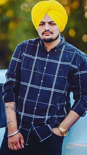 Sidhu Moose Wala Portrait Wearing Yellow Turban and Plaid Shirt HD phone wallpaper