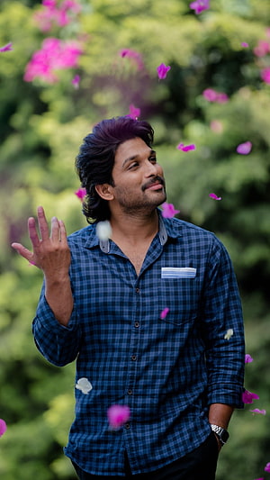 Allu Arjun in Blue Checkered Shirt with Falling Pink Flower Petals HD phone wallpaper