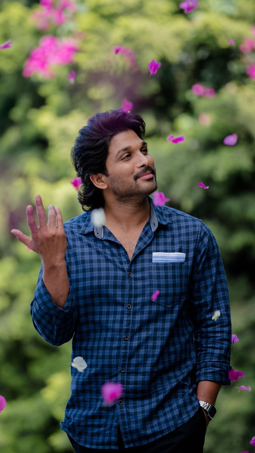 Allu Arjun in Blue Checkered Shirt with Falling Pink Flower Petals HD phone wallpaper