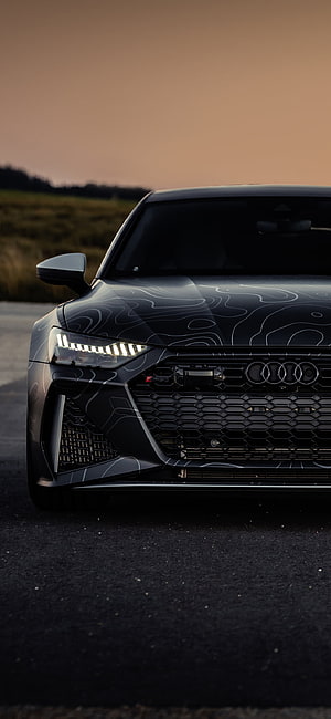 Black Audi RS7 Sportback with Topographic Wrap on Road at Sunset HD phone wallpaper