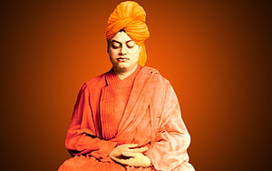 Portrait of a Spiritual Leader in Orange Robes and Turban Meditating HD wallpaper