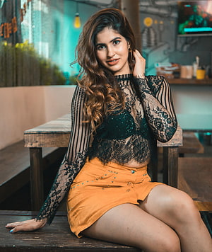 Sakshi Malik in Black Lace Top and Orange Skirt at Cafe HD phone wallpaper