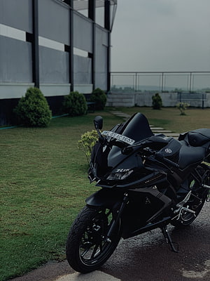 Matte Black Yamaha R15 Sport Motorcycle Parked on Grass HD phone wallpaper