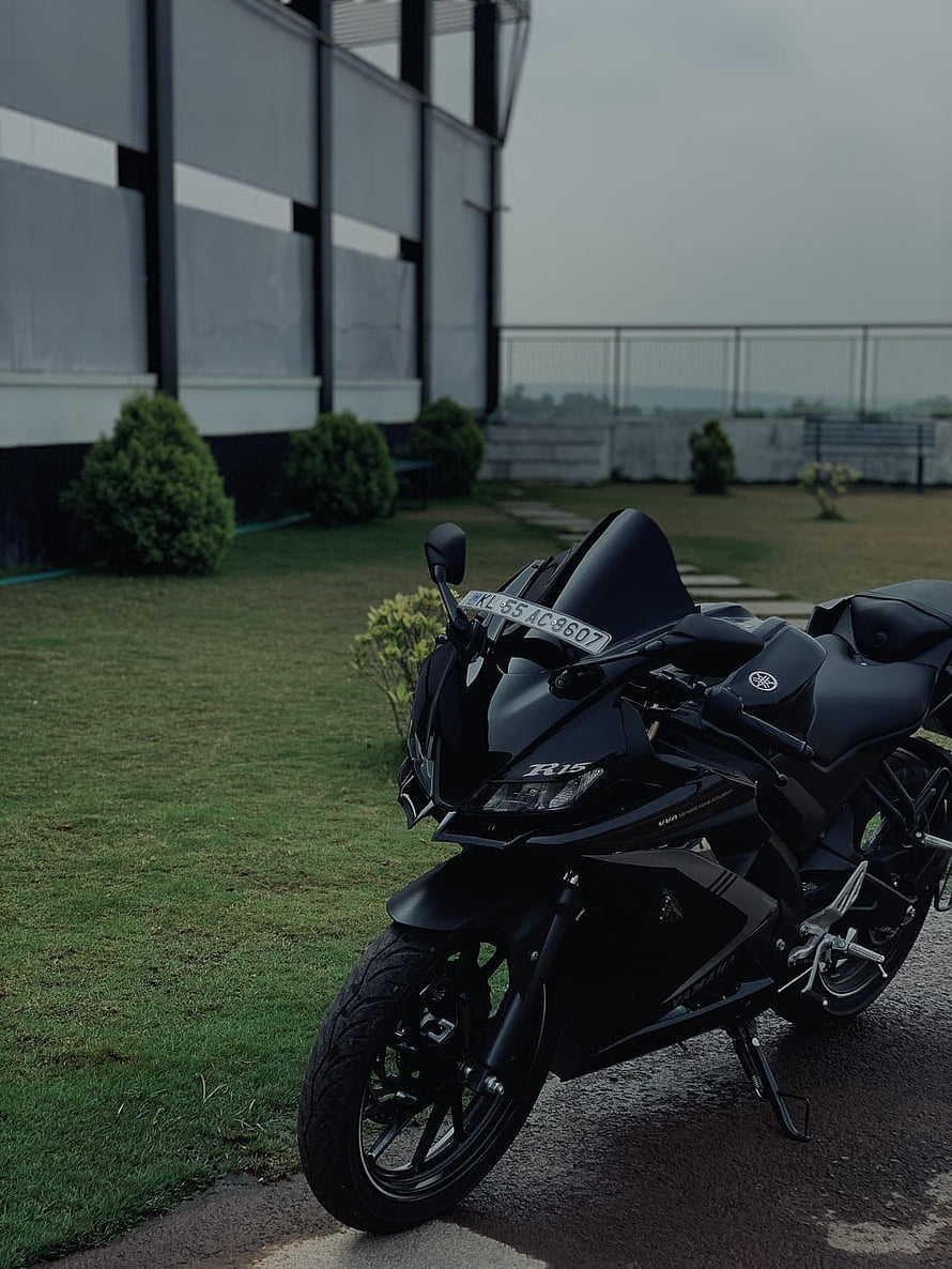 Matte Black Yamaha R15 Sport Motorcycle Parked on Grass HD phone wallpaper