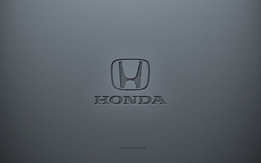 Honda emblem embossed on a smooth gray metallic surface with subtle texture and soft lighting HD wallpaper