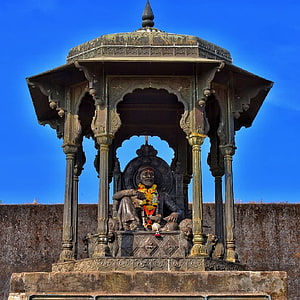 Ornate Bronze Temple Pavilion With Seated Deity Statue Under Blue Sky HD phone wallpaper