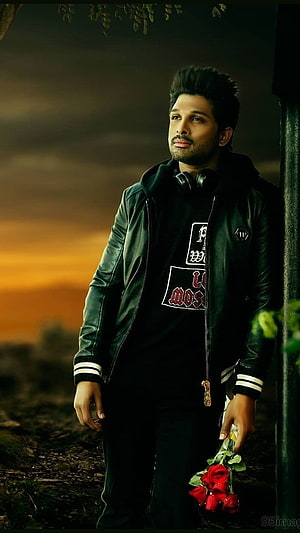 Allu Arjun in a black leather jacket holding red roses against a sunset background HD phone wallpaper