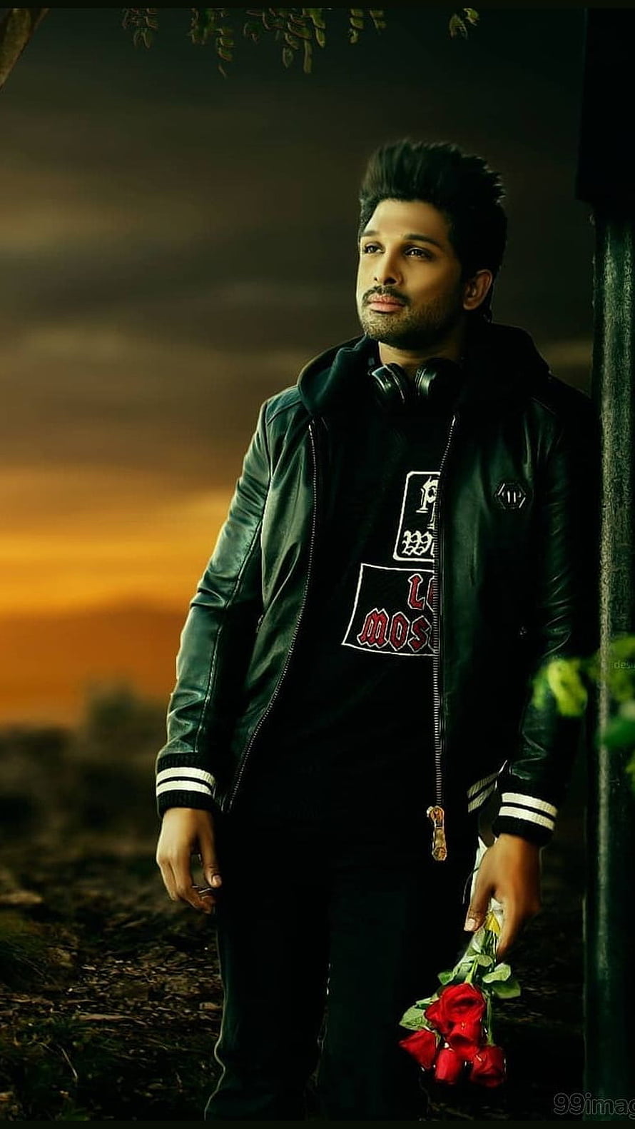 Allu Arjun in a black leather jacket holding red roses against a sunset background HD phone wallpaper
