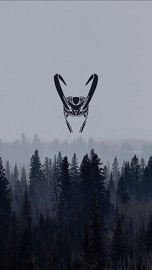 Loki Minimalist Mask Silhouette Over Misty Pine Forest Landscape HD phone wallpaper