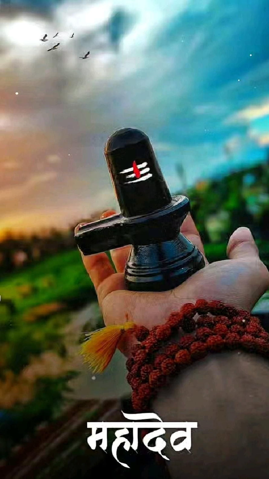 Hand Holding Black Shiva Lingam With Rudraksha Mala Against Sunset Sky HD phone wallpaper