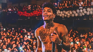 MC Kevin performing shirtless on stage with microphone in front of a large concert crowd HD wallpaper
