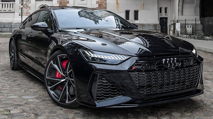 Black Audi RS7 Sportback with Red Brakes Parked on Cobblestone Street HD wallpaper