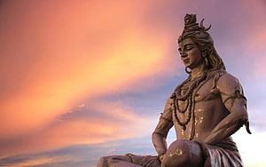Lord Shiva Statue in Rishikesh Against a Vibrant Sunset Sky HD wallpaper