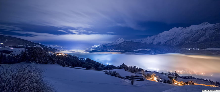 Snowy Mountain Landscape at Night with Fog and Village Lights HD wallpaper
