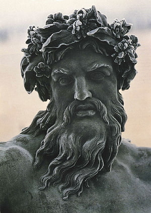 Close-up of a bearded Zeus statue wearing a floral crown in classical Greek sculpture style HD phone wallpaper