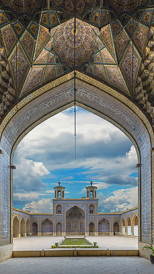 Ornate Muqarnas Archway Framing the Courtyard of the Juma Mosque in Khiva, Uzbekistan HD phone wallpaper