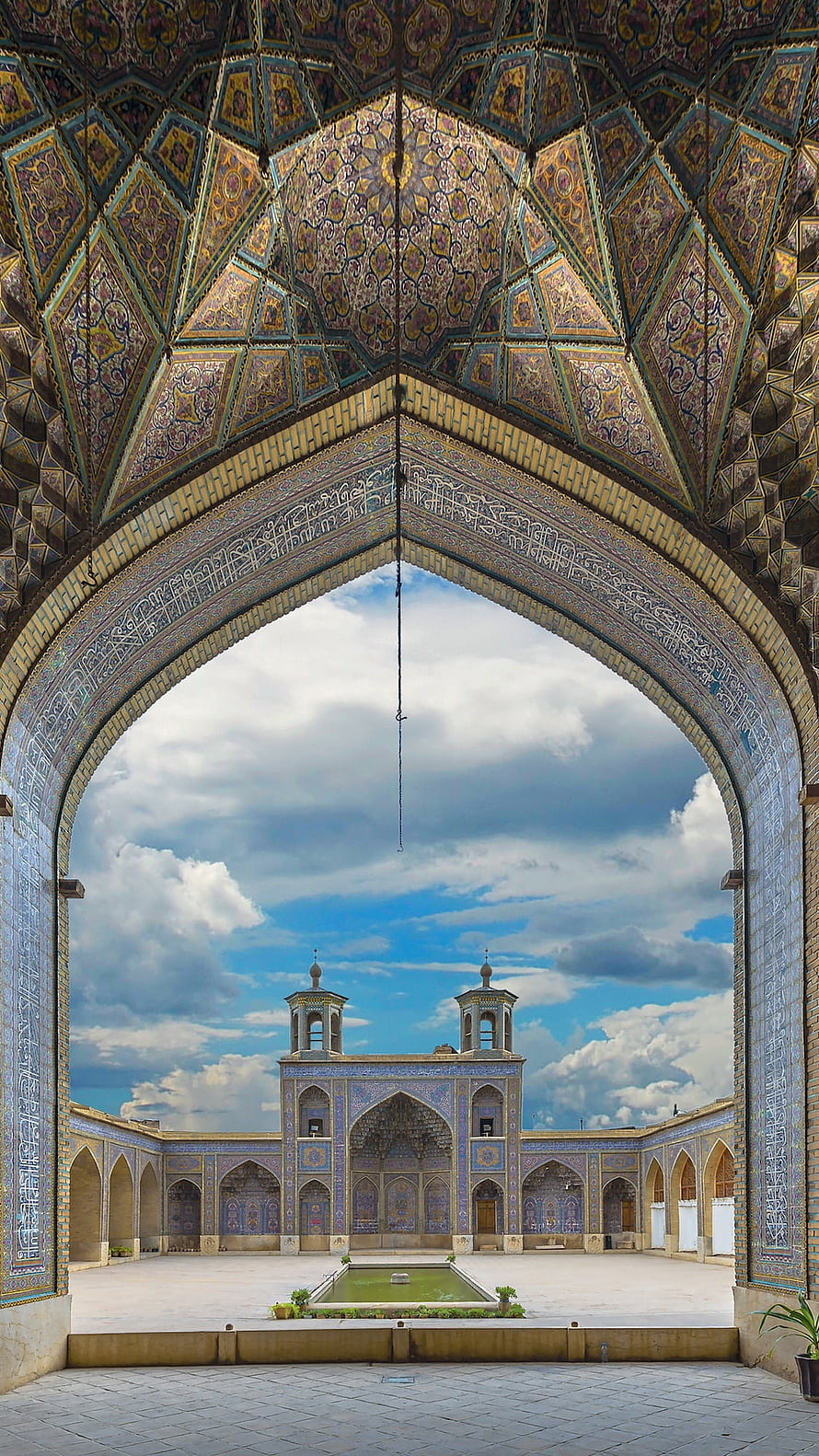Ornate Muqarnas Archway Framing the Courtyard of the Juma Mosque in Khiva, Uzbekistan HD phone wallpaper