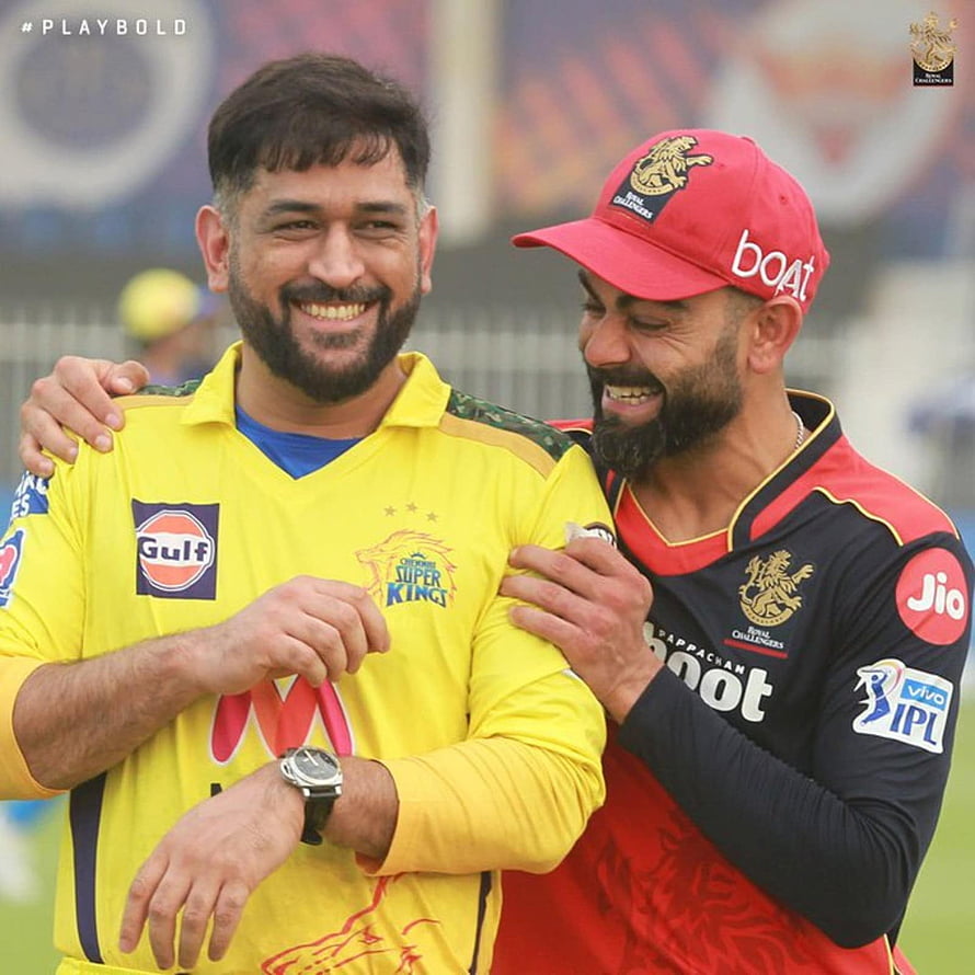 Virat Kohli and KL Rahul sharing a laugh during an IPL cricket match in team jerseys HD phone wallpaper