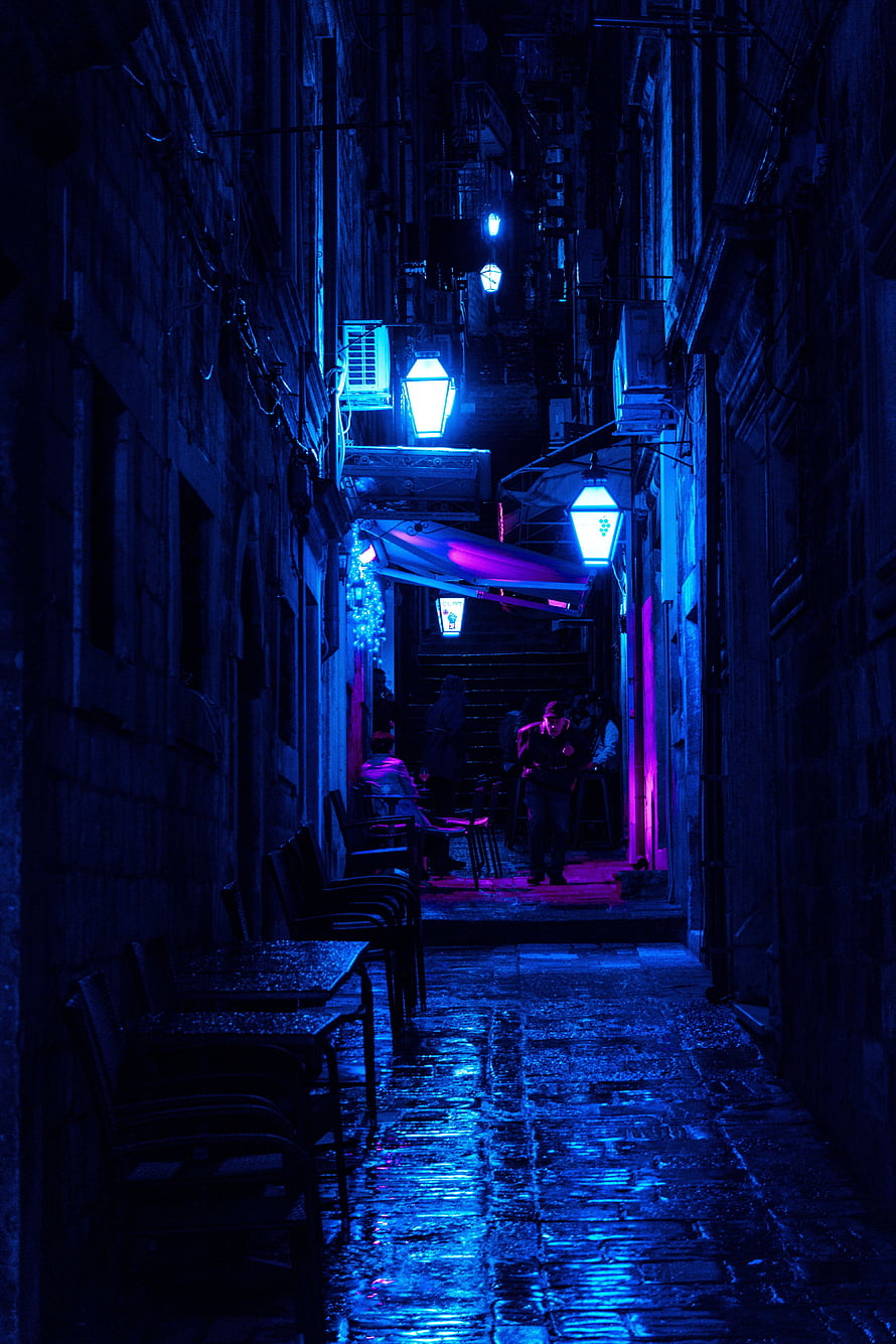 Moody Nighttime Alleyway With Neon Lights And Wet Cobblestones HD phone wallpaper