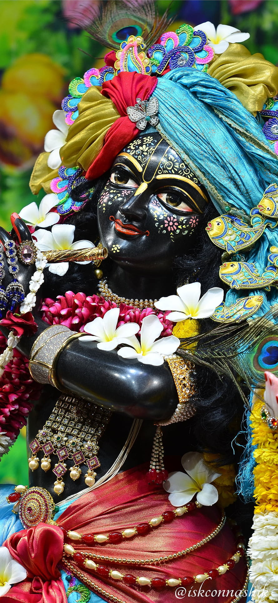Colorful Krishna Deity Statue Playing Flute with Peacock Feather Crown HD phone wallpaper