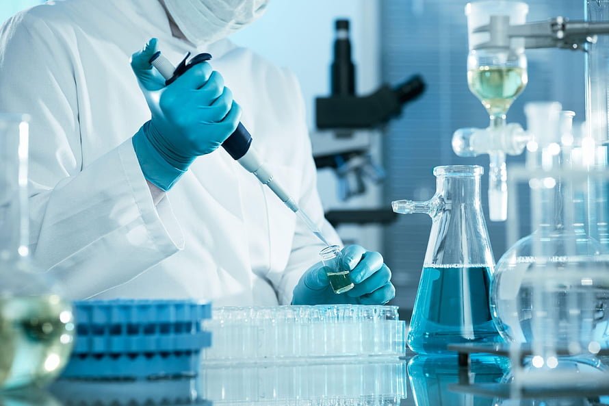 Scientist in White Coat Using Pipette in Blue-Tinted Medical Laboratory HD wallpaper