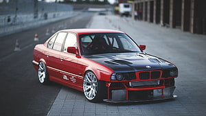 Red BMW E34 M5 Race Car with Black Hood and Front Splitter on Track HD wallpaper
