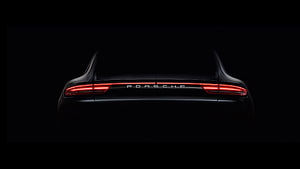 Porsche Rear View with Glowing Red Taillights Against a Dark Background HD wallpaper