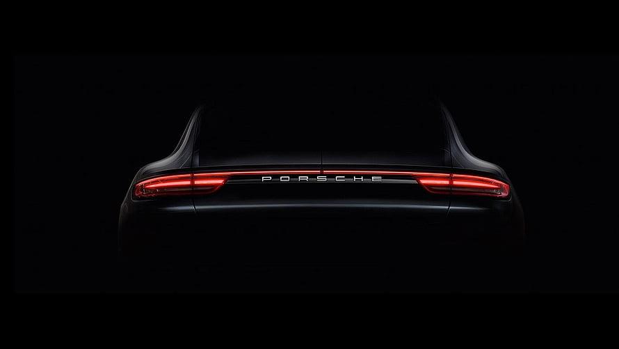 Porsche Rear View with Glowing Red Taillights Against a Dark Background HD wallpaper