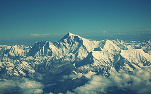 Aerial View of Snow-Capped Himalayan Peaks Rising Above a Sea of Clouds HD wallpaper