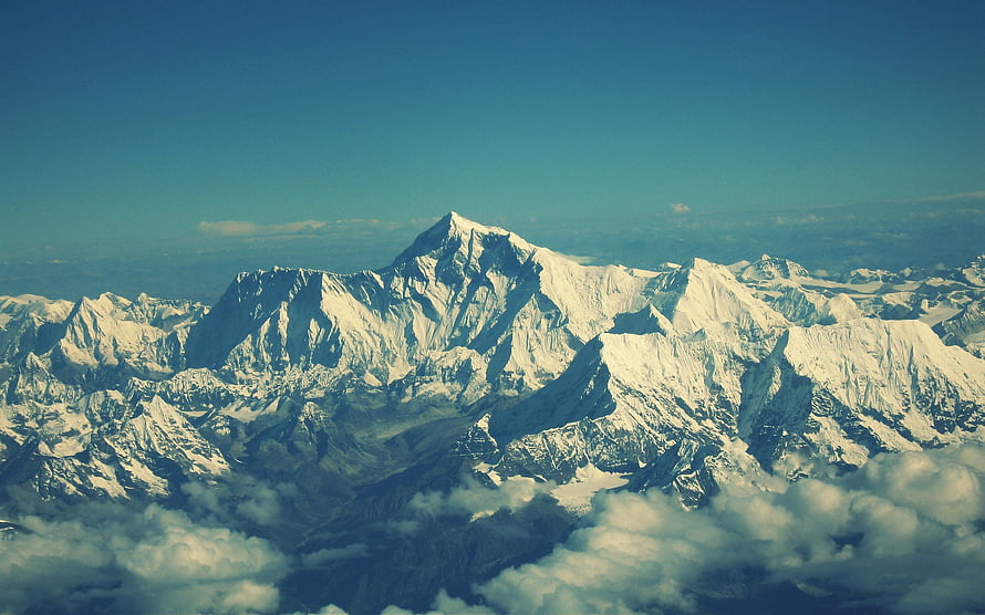 Aerial View of Snow-Capped Himalayan Peaks Rising Above a Sea of Clouds HD wallpaper